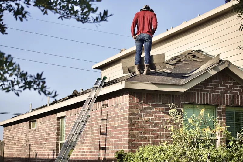 Professional roofer working on a residential roof in Ibis Golf and Country Club